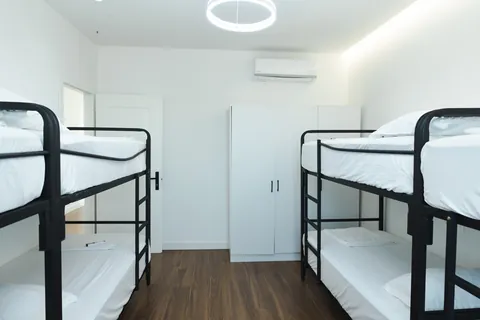 Bunk-bed room with a white wardrobe and air conditioning
